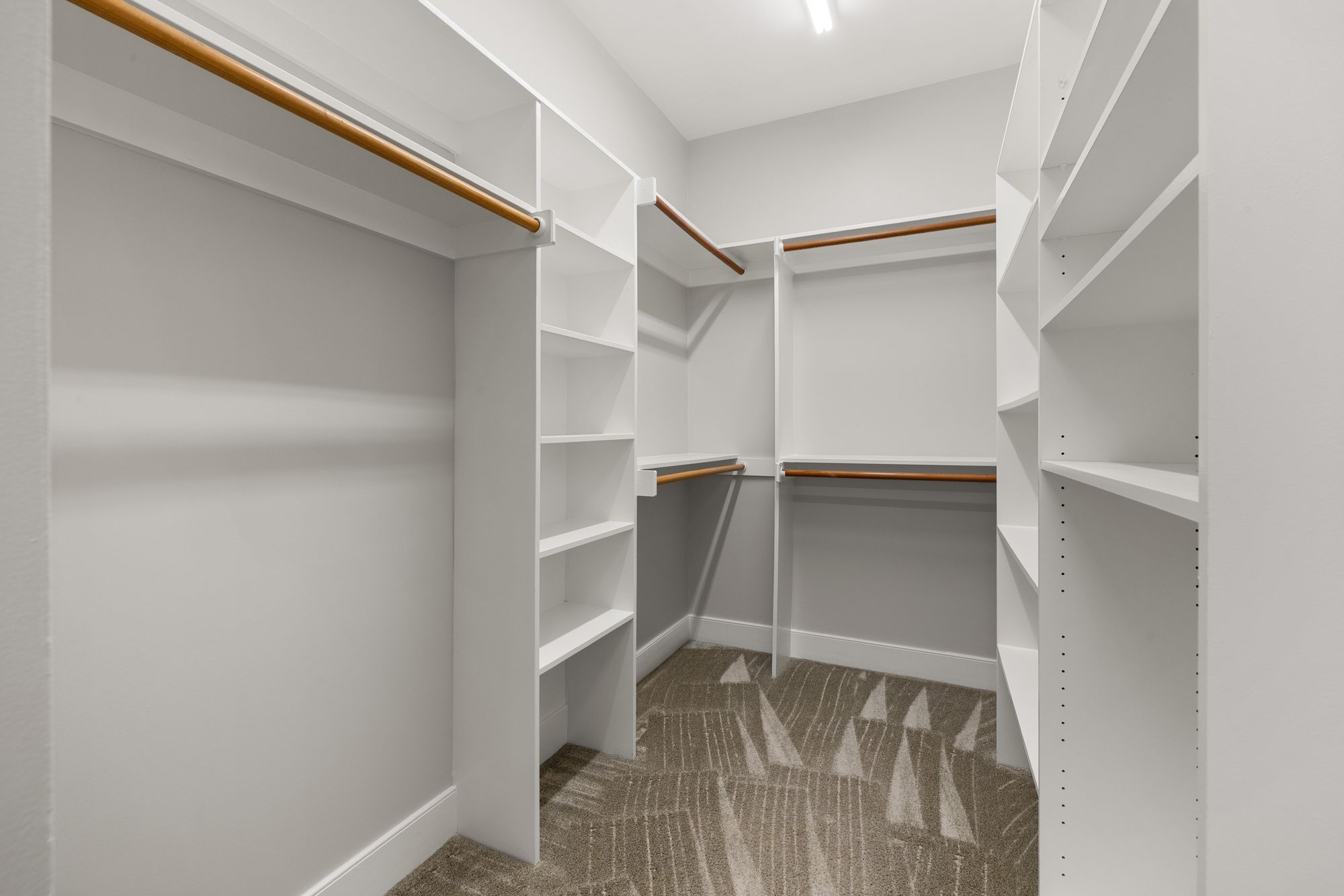 Before: builder-standard white wire closet shelving