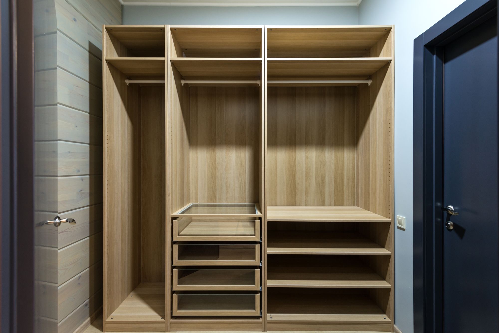 Custom reach-in closet with oak shelving and drawers