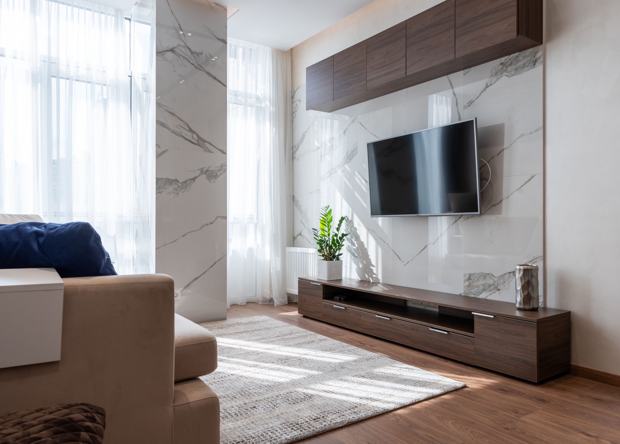 Media wall with stone-look panel and floating cabinetry
