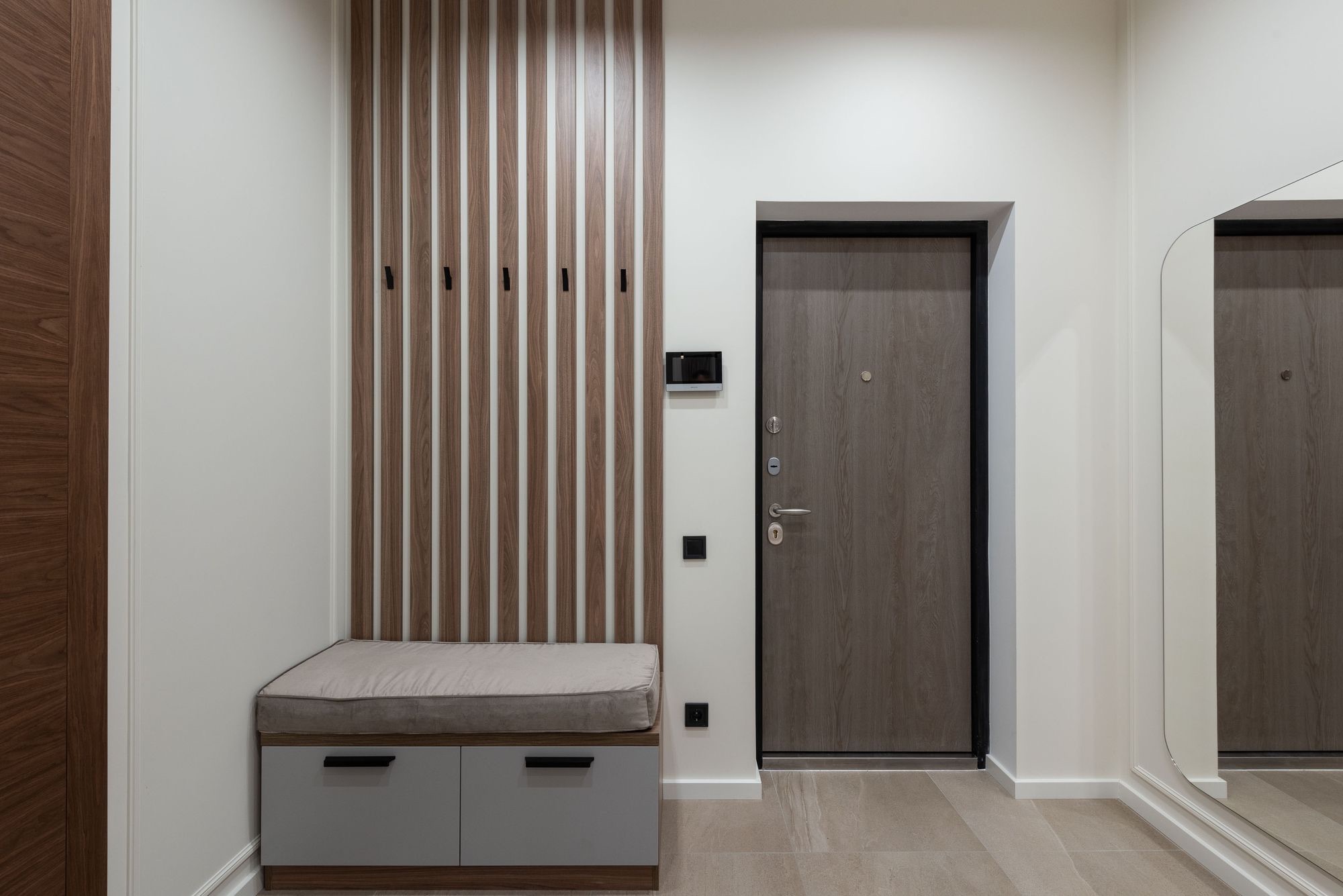Entry mudroom with slatted wall panel and bench storage